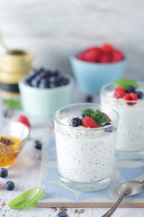 Greek yogurt in glasses with berries and quinoa