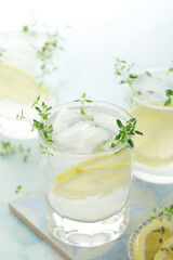 Obraz na płótnie Canvas Glasses with lemon and thyme refreshing drink 