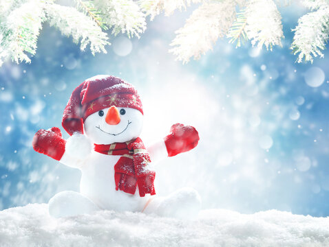 Merry christmas and happy new year greeting card .Happy snowman standing in winter christmas landscape.Snow background
