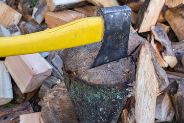 An ax and a stump while chopping firewood on a clear day. Heating.