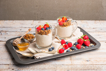 Granola with nuts, yogurt and red fruits berries in a jar. Breakfast parfait with muesli, yoghurt,...