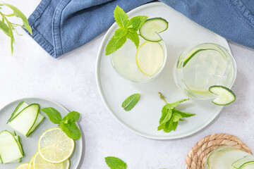 Refreshing infused water with cucumber, mint and lime. Summer drink cocktail lemonade. Healthy drink and detox concept