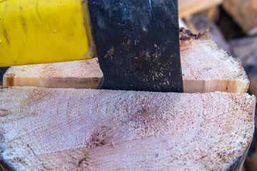 An ax and a stump while chopping firewood on a clear day. Heating.