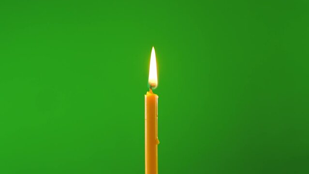 fire flame glowing candle on windy on green screen background of slow motion