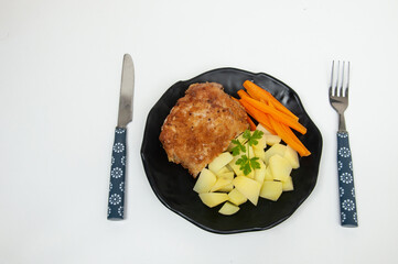  salad dish with potato, carrot, lettuce and breaded pork steak - obrazy, fototapety, plakaty