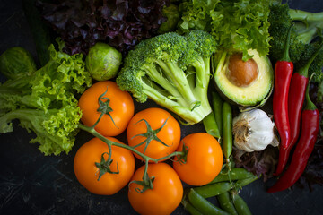 Fresh vegetables and fruits on a dark background