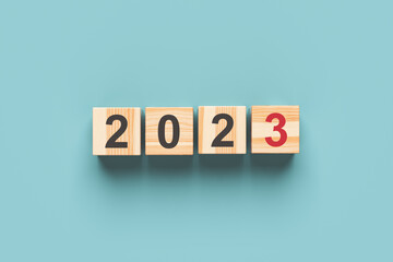 2023 new year. Wooden cubes with 2023 on a blue background. 3d rendering.