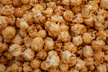 Caramel popcorn background, top view