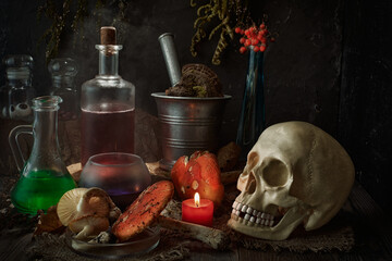 Still life in a low key - a table with attributes of witch spells and charms