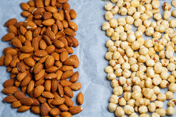 Roasted delicious nuts almonds and hazelnuts on a white background.