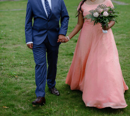 Indian bridal couple posing together. Bride wears gorgeous pink wedding dress. - 539821417