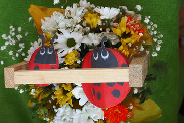  bouquet of flowers and decor paper ladybugs in a wooden gift box