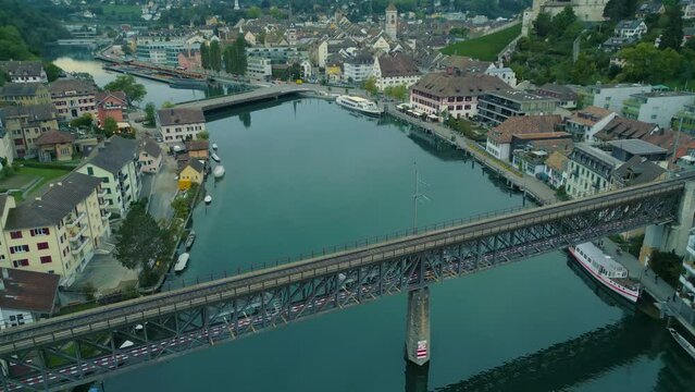Revealing drone shot of Schaffhausen city centre with rail bridge and Munot fortress