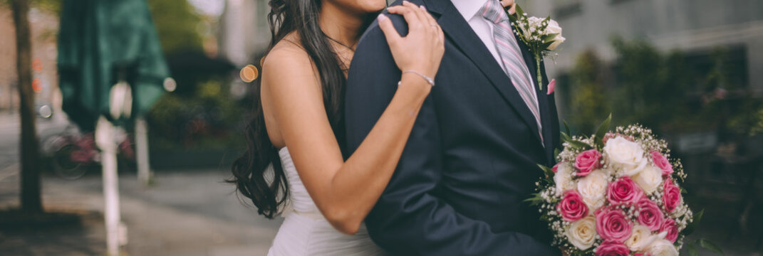 a bride from Latin America and caucasian groom, bridal couple in love, happy wedding day