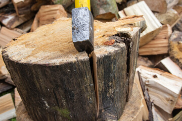 An ax and a stump while chopping firewood on a clear day. Heating.