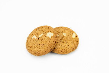 closeup of two brown cookies with white peanut or nut put overlapping, fresh  homemade round bakery. danish christmas cookie isolated on white background, clipping path top view