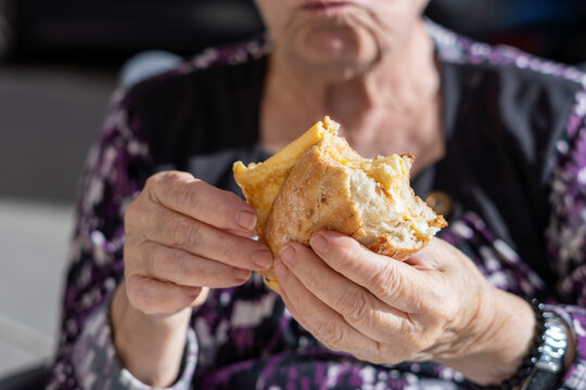 Close-up, Hands Of An Older Woman With A Sandwich