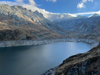 Obraz premium Artificial reservoir lake Lago di Lucendro or accumulation lake Lucendro in the Swiss alpine area of the St. Gotthard Pass (Gotthardpass), Airolo - Canton of Ticino (Tessin), Switzerland (Schweiz)