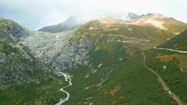 Aerial view of valley and waterfall from melted glacier Rhonegletscher