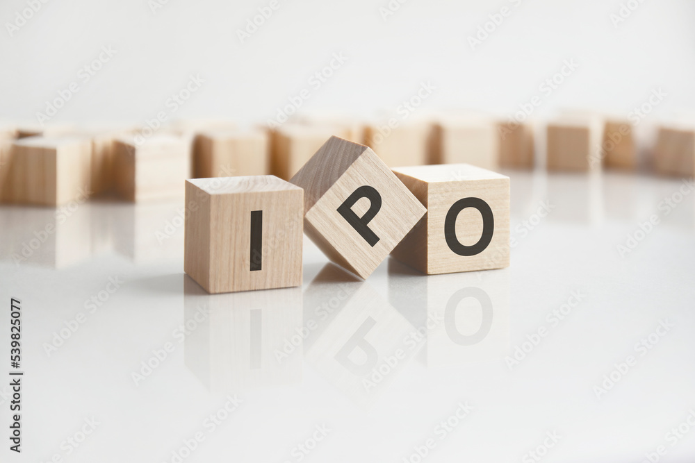 Poster text ipo on wooden blocks with letters on a white background. reflection of the caption on the mirro