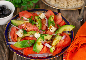 Fresh vegetable salad with tomatoes, avocado and shallots