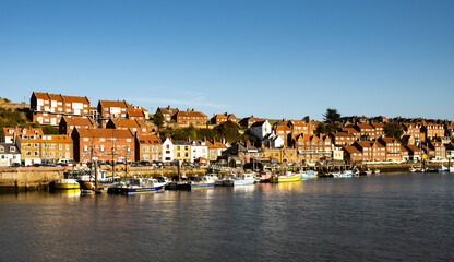 Fototapeta na wymiar View over Whitby harbour illuminated by the golden afternoon sunlight, North Yorkshire