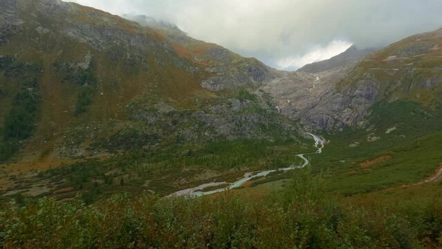Timelapse View at Goms valley, Rotten river and rolling clouds going from behind the mountain