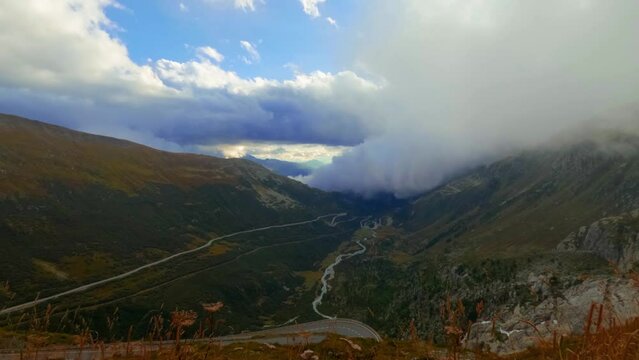 Timelapse View at Goms valley, Rotten river and rolling clouds going from behind the mountain