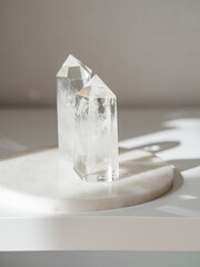 Collection of crystals quartz on a white background with shadows from sunlight.