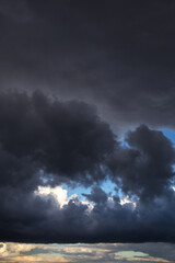 Epic Dramatic storm dark black cumulus rain cloud against blue sky background texture, thunderstorm