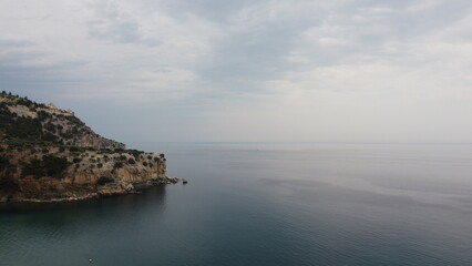 Cliffs jutting far into the sea meet calm seas at a bay on the island of Thassos. North Aegean Sea in Greece. An undiscovered vacation paradise for relaxing and snorkeling.