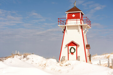 Covehead lighthouse decorated with a Christmas wreath. Located in PEI National Park, Prince Edward Island, Canada.