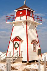 Covehead lighthouse decorated with a Christmas wreath. Located in PEI National Park, Prince Edward Island, Canada.
