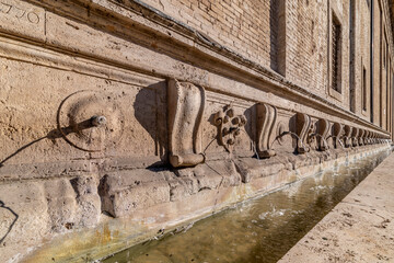 Fountain of the 26 Spouts along the external side of the Basilica of Santa Maria degli Angeli, Assisi, Italy - obrazy, fototapety, plakaty