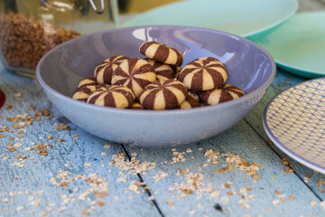 Sweet chocolate brownies on rustic wooden table with flakes