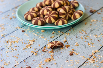 Sweet chocolate brownies on rustic wooden table with flakes