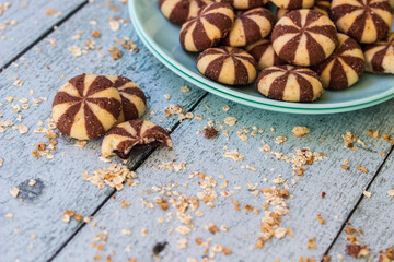 Sweet chocolate brownies on rustic wooden table with flakes