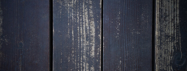 Rectangular background made of wooden boards. The shape of a banner with a dark wooden fence.