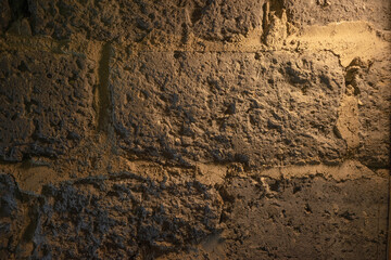 Gloomy concrete masonry in the basement. Photo of the wall of the old dungeon in the castle.Grey concrete background for text.Concrete blocks in the bunker.