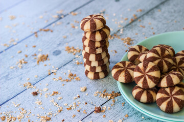 Sweet chocolate brownies on rustic wooden table with flakes