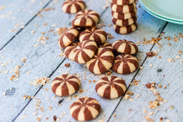Sweet chocolate brownies on rustic wooden table with flakes