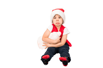 Portrait of unhappy resentful little child in red Santa Claus hat isolated on white background. Beautiful five-year European boy. Bad gift. Copy space. Merry Christmas. Bad mood. Close-up. New Year