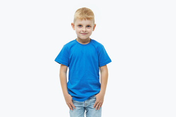 Stylish child boy model in a blue casual t-shirt on a white isolated background