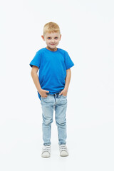 Stylish child boy model in a blue casual t-shirt on a white isolated background
