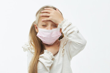 Cute ill child girl in a protective face mask. holding hands on neck. Protection against flu and cold diseases during a pandemic. White isolated background
