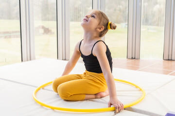 Little blonde girl with piggy tails playing with hula hoop © stivog