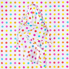 Funny ghost with colorful polka dots on an edentulous background. Mystical sign, avatar.
