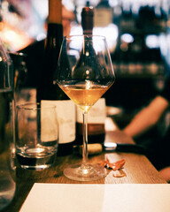 Orange wine being poured in a dimly lit environment.