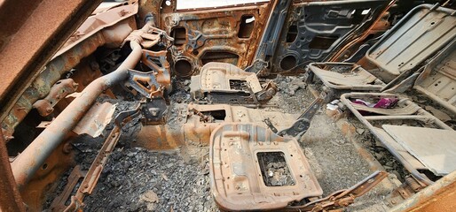 Old rusted torched car, abandoned car on highway mumbai.