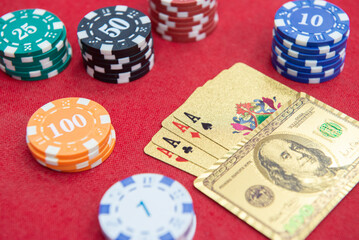 Four of aces near stacks of chips on a red felt table